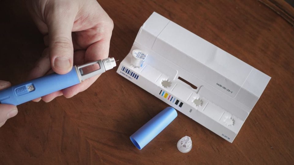 I Said No to a GLP-1 for Years. Here Are the Questions to Ask Your Doctor When You Finally Say Yes Person Preparing Semaglutide Ozempic Injection